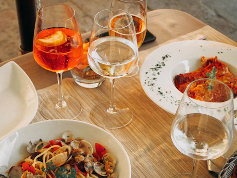 A dining table with food and wine glasses; stock atmosphere, not Royal King's restaurant or dishes.